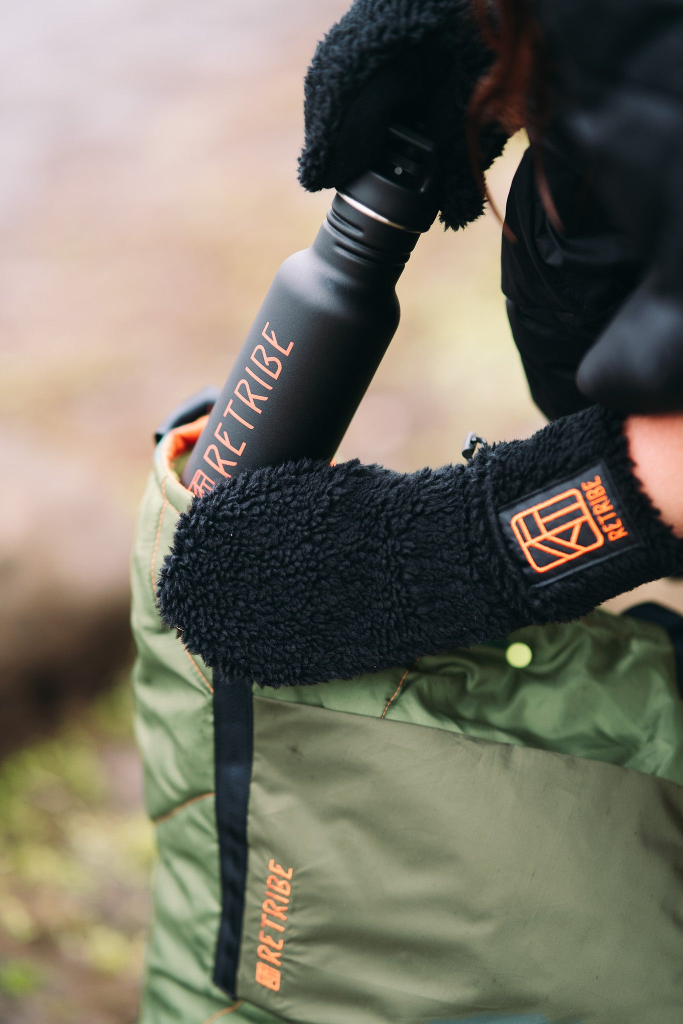 Remade tote bag, made from salvaged sleeping bags. With a front pocket made from salvaged green tent material. Embroidered with the Retribe logo vertically in the left hand side corner. Black webbing straps make the bag stable and strong. The bag closes with a popper in the centre. 